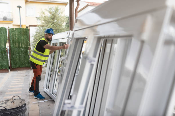 construction worker prepares the aluminum window frames to be placed on the construction site - fenêtres photos et images de collection